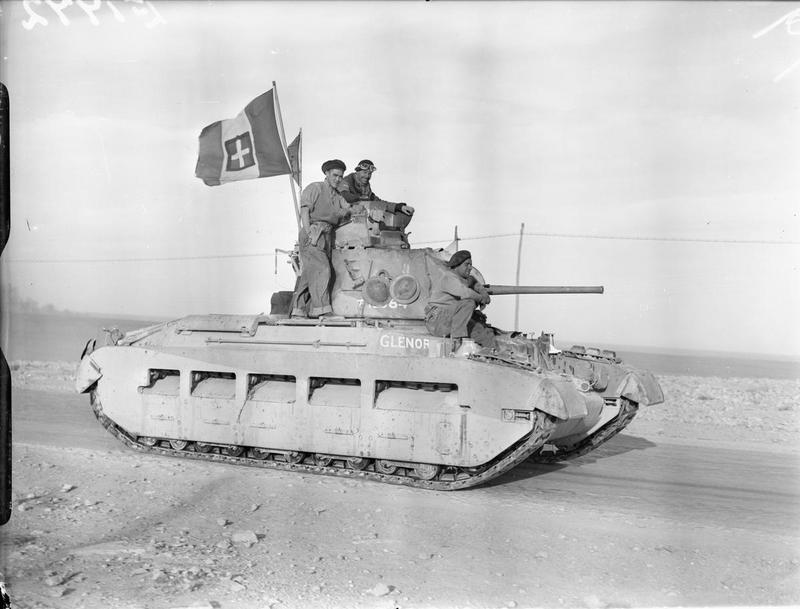 Imperial War Museum E1772: A British Matilda tank on its way into Tobruk, displaying an Italian flag, 24 January 1941.