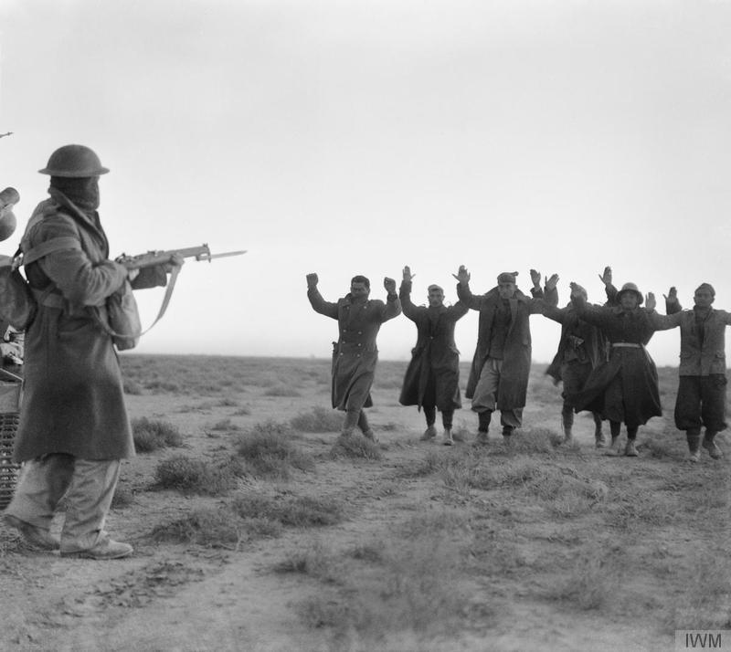 IWM E1580: Italian soldiers surrendering to an Australian infantryman during the attack on Bardia, Libya.